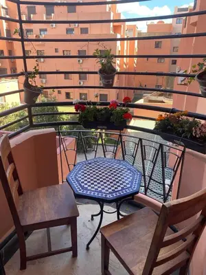 a table and chairs on a balcony with a building at Elegance and comfort in the heart of Marrakech in Marrakech