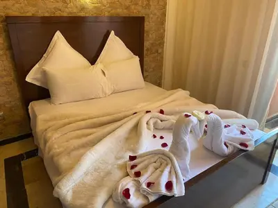 a bedroom with a bed with towels on it at Elegance and comfort in the heart of Marrakech in Marrakech