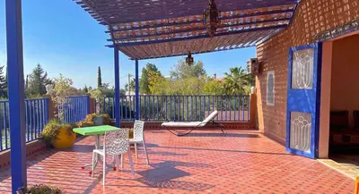 a patio with a table and chairs and a fence at Charming Family Villa with Private Pool & Garden - Near Marrakech in Sraïri