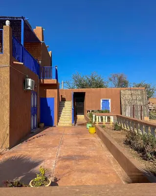a building with a blue door and a stairway at Charming Family Villa with Private Pool & Garden - Near Marrakech in Sraïri
