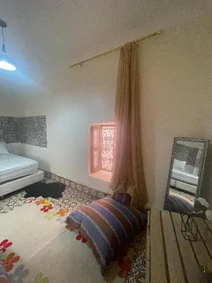 a bedroom with a mirror and a bed in it at Dar darkoum in Marrakech