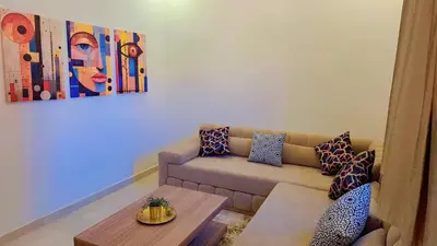 a living room with a couch and a table at Appartement Aéroport Marrakech Rest in Marrakech
