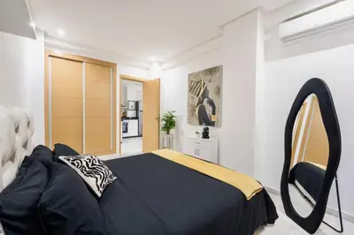 a bedroom with a large bed and a mirror at Terrace & Fast Wi-Fi - Stylish city center flat - Gueliz in Marrakech
