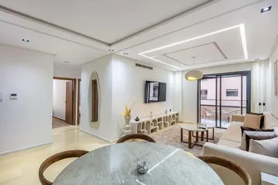 a living room with a table and a couch at Modern apartment close to M Avenue & Menara Mall in Marrakech