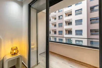 a room with a window and a table and a building at Modern apartment close to M Avenue & Menara Mall in Marrakech