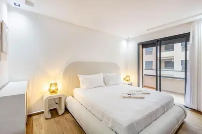 a white bedroom with a large bed and a window at Modern apartment close to M Avenue & Menara Mall in Marrakech