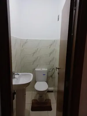 a bathroom with a white toilet and a sink at Marrakech in Marrakech