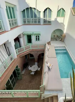 an aerial view of a house with a swimming pool at Riad Birdy, Charmant et privatif, Piscine, Rooftop, 6 suites, 2 salons, Wifi in Marrakech