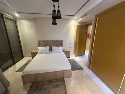 a bedroom with a large white bed in a room at Karam eddin in Marrakech