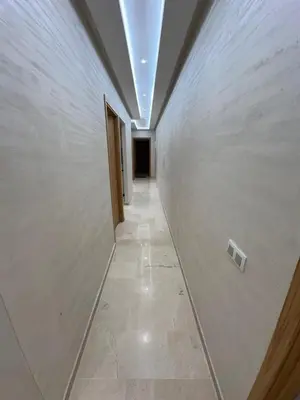 an empty hallway with a white wall and a hallway at Karam eddin in Marrakech