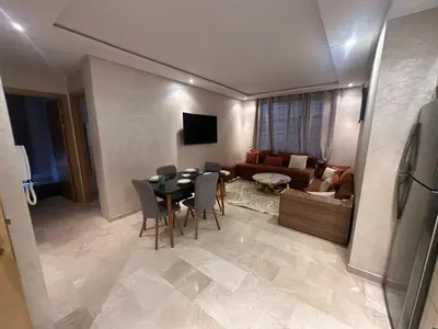 a living room with a table and a couch at Karam eddin in Marrakech