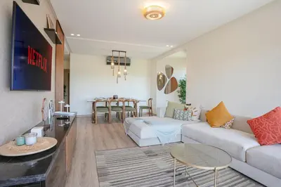 a living room with a couch and a table at Saphire Luxury - Marrakech- Prestigia in Marrakech