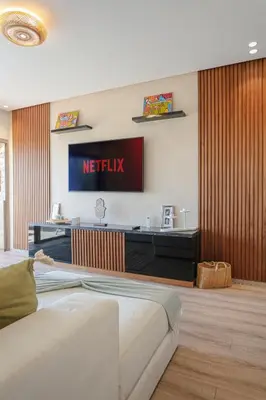 a hotel room with a television on the wall at Saphire Luxury - Marrakech- Prestigia in Marrakech