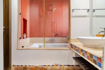 a bathroom with a shower and a sink and a tub at appartement avec piscine et charme marocain in Marrakech