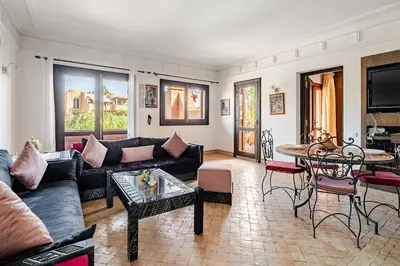 a living room with a couch and a table at appartement avec piscine et charme marocain in Marrakech