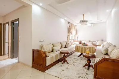 a living room with a couch and a table at Moroccan Comfort & Charm - 10 min from Guéliz in Marrakech