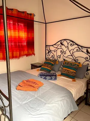 a bedroom with two beds and a canopy bed at Riad Serenity Palmeraie in Marrakech
