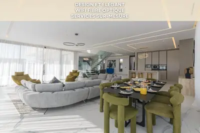 a living room with a couch and a table at Villa Sofya - Roche Bobois Design & HD Wifi in Marrakech