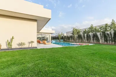 a large yard with a swimming pool in a house at Villa Sofya - Roche Bobois Design & HD Wifi in Marrakech