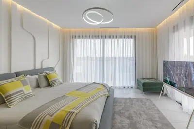 a bedroom with a large bed and a large window at Villa Sofya - Roche Bobois Design & HD Wifi in Marrakech