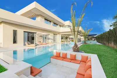 a villa with a swimming pool and a house at Villa Sofya - Roche Bobois Design & HD Wifi in Marrakech