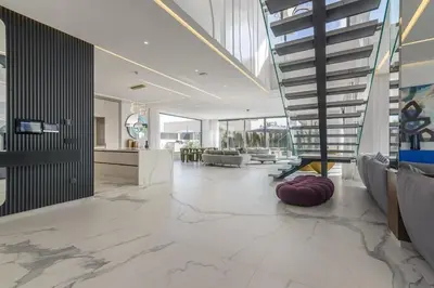 a lobby with a staircase and a living room at Villa Sofya - Roche Bobois Design & HD Wifi in Marrakech