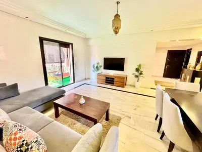 a living room with a couch and a table at Perfect stay in Guéliz Book now! in Marrakech