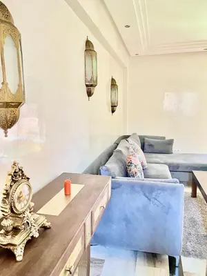 a living room with a blue couch and a table at Perfect stay in Guéliz Book now! in Marrakech