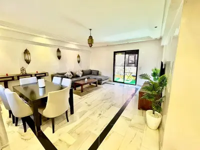 a living room with a table and a couch at Perfect stay in Guéliz Book now! in Marrakech