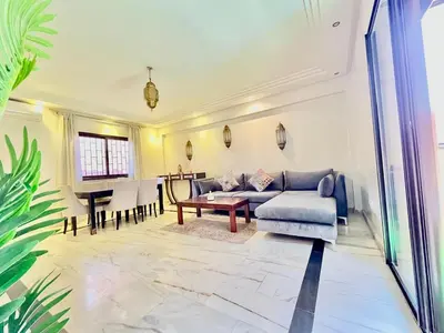 a living room with a couch and a table at Perfect stay in Guéliz Book now! in Marrakech