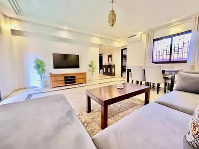 a living room with a couch and a table at Perfect stay in Guéliz Book now! in Marrakech