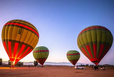 a group of hot air balloons in a field at La Bella Casa - Private Pool in Marrakech