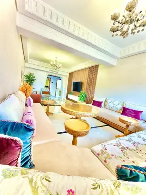 a living room with couches and a table at Appartement Plaza Centre in Marrakech