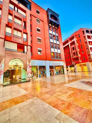an empty street in a city with buildings at Appartement Plaza Centre in Marrakech