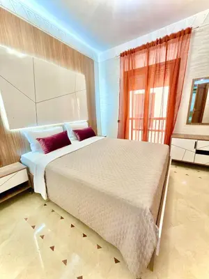 a bedroom with a large bed and a window at Appartement Plaza Centre in Marrakech