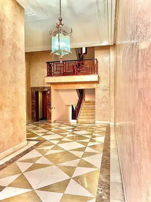 a lobby with a staircase and a chandelier at Appartement Plaza Centre in Marrakech