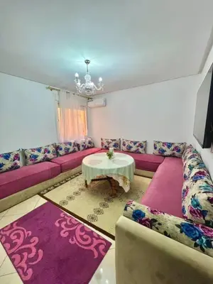 a living room with a couch and a table at Modern apartment in the heart of Marrakech, just 9 minutes from the airport in Marrakech