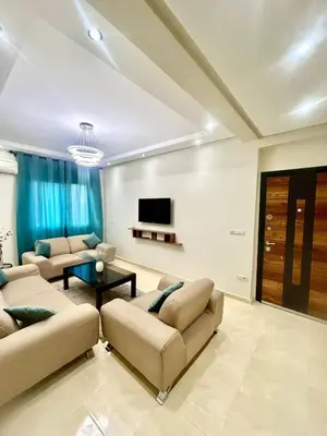 a living room with two couches and a flat screen tv at Cozy Apartment 10 minutes from Gueliz and Medina in Marrakech