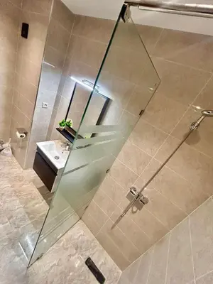 a shower with a glass door in a bathroom at Cozy Apartment 10 minutes from Gueliz and Medina in Marrakech