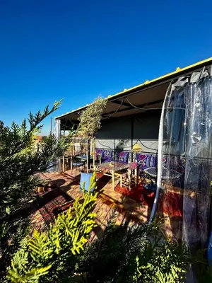 a building with a patio with tables and chairs at Dar Koutobia Stars in Marrakech