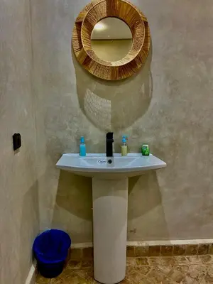 a bathroom with a sink with a mirror on the wall at Dar Koutobia Stars in Marrakech