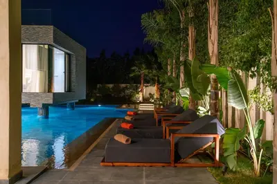 a pool with a bunch of lounge chairs next to a building at Villa Lana on stilts luxury and relaxation in Marrakech