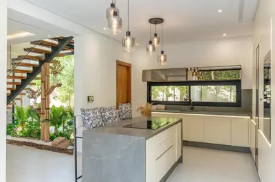 a kitchen with a large island and a staircase at Villa Lana on stilts luxury and relaxation in Marrakech