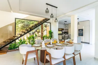 a dining room with a table and white chairs at Villa Lana on stilts luxury and relaxation in Marrakech
