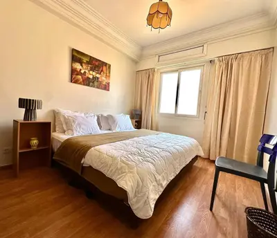 a bedroom with a large bed and a window at Charming apartment with a traditional style in Marrakech