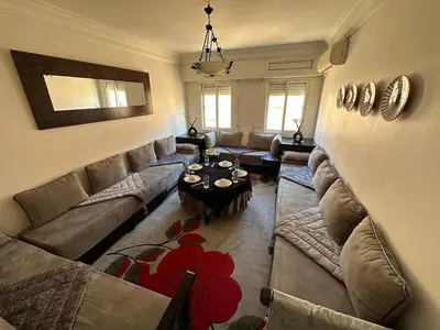 a living room with a couch and a table at Charming apartment with a traditional style in Marrakech