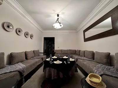 a living room with a couch and a table at Charming apartment with a traditional style in Marrakech