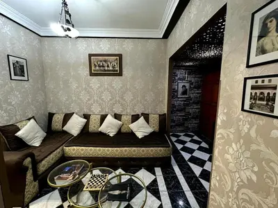 a room with a bed and a table in it at Charming apartment with a traditional style in Marrakech
