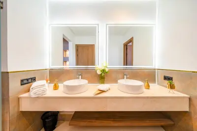 a bathroom with two sinks and a large mirror at Luxury 5-Suite Villa with private pool in GOLF Amlkis ,free Airport transport service in Marrakech