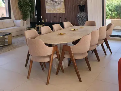 a wooden table and chairs in a living room at Luxury 5-Suite Villa with private pool in GOLF Amlkis ,free Airport transport service in Marrakech